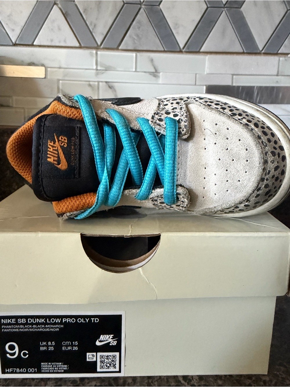 Nike Kids SB Dunk Low in White with Teal Laces and Orange Accents